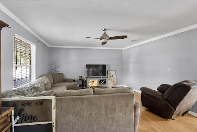 living room featuring ornamental molding, ceiling fan, and light hardwood / wood-style floors