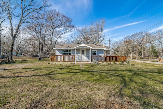 view of front of house with a front yard and a wooden deck