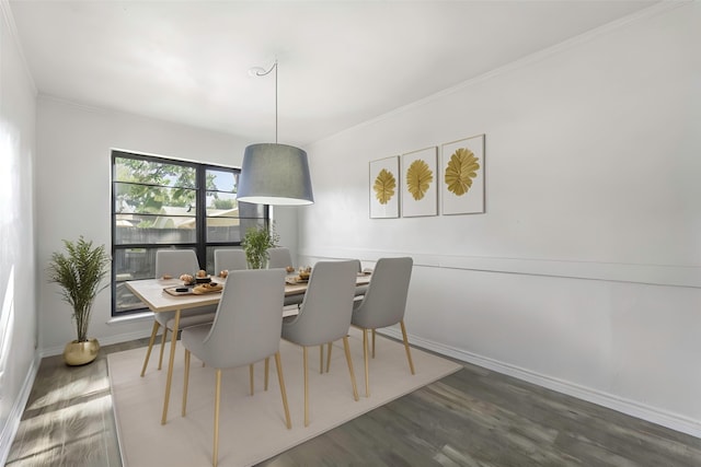 dining area featuring dark hardwood / wood-style flooring and ornamental molding