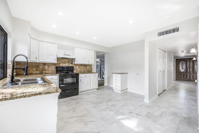 kitchen featuring white cabinetry, electric range, sink, light stone countertops, and decorative backsplash