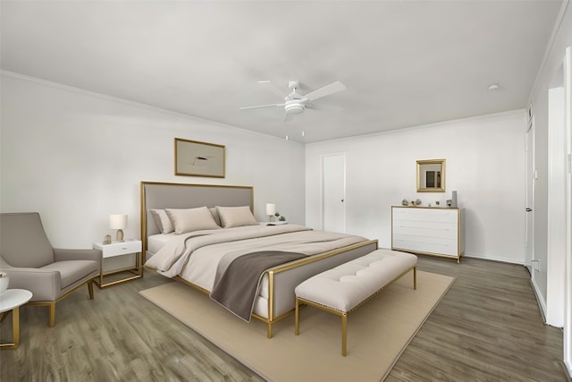 bedroom featuring ceiling fan, dark hardwood / wood-style flooring, and crown molding