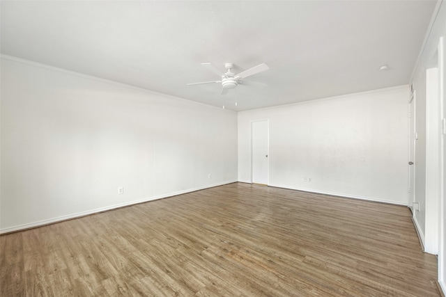 empty room featuring wood-type flooring, crown molding, and ceiling fan