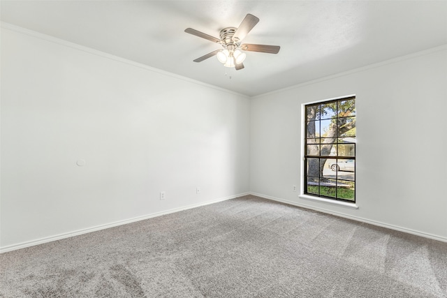 carpeted empty room featuring crown molding and ceiling fan