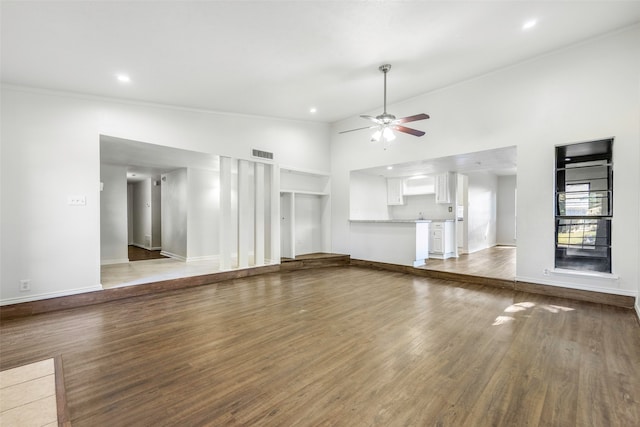 unfurnished living room with hardwood / wood-style floors, high vaulted ceiling, ceiling fan, and ornamental molding