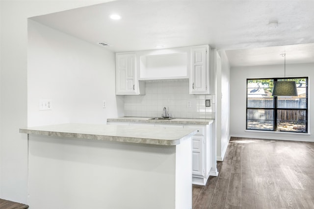 kitchen featuring white cabinets, pendant lighting, and sink