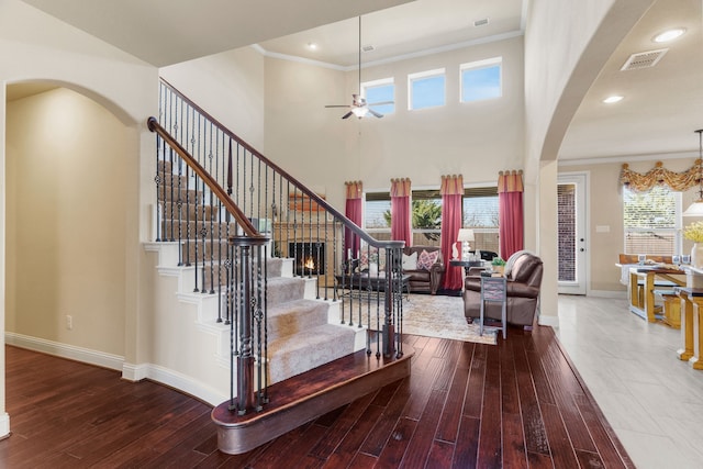 10014 Edgeway Cir, Rowlett, TX 75089 - stairway with arched walkways, baseboards, ceiling fan, hardwood / wood-style floors, and ornamental molding