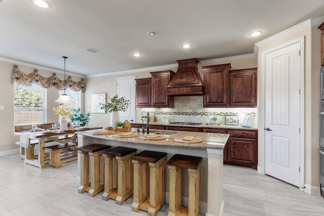 10014 Edgeway Cir, Rowlett, TX 75089 - kitchen with premium range hood, tasteful backsplash, gas cooktop, a sink, and light stone countertops
