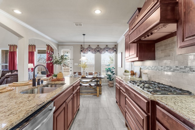 10014 Edgeway Cir, Rowlett, TX 75089 - kitchen featuring a sink, appliances with stainless steel finishes, wall chimney range hood, light stone counters, and decorative backsplash