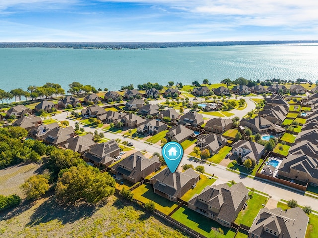 drone / aerial view featuring a water view and a residential view