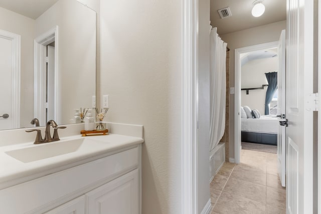 10014 Edgeway Cir, Rowlett, TX 75089 - ensuite bathroom featuring vanity, tile patterned floors, and shower / bath combo