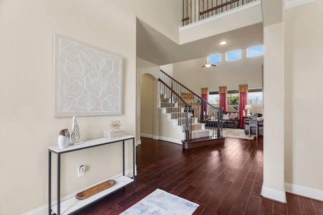 10014 Edgeway Cir, Rowlett, TX 75089 - foyer entrance with a high ceiling, stairway, baseboards, wood finished floors, and arched walkways