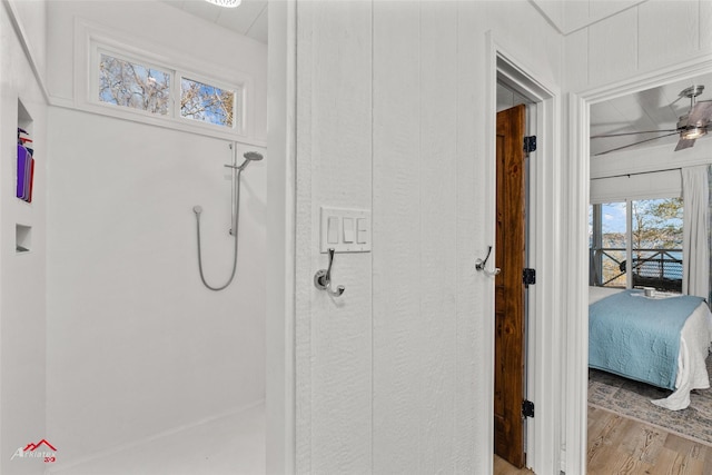 bathroom featuring hardwood / wood-style floors, ceiling fan, and walk in shower