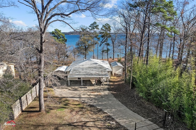 view of yard with a carport and a water view