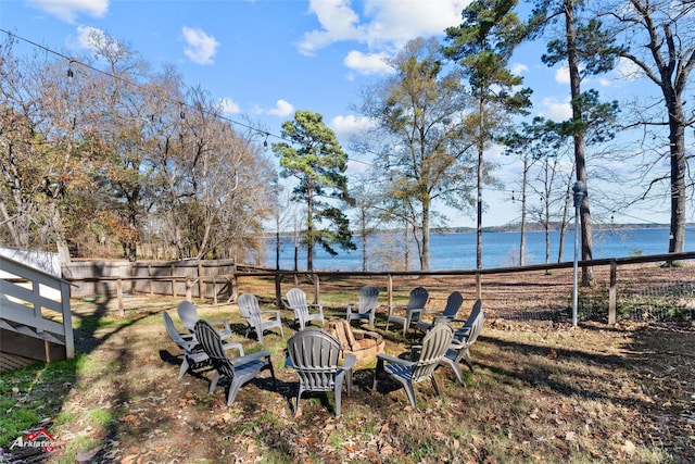 view of yard featuring a water view and a fire pit