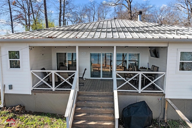 wooden terrace featuring a porch and area for grilling