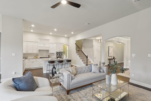 living room featuring ceiling fan and wood-type flooring