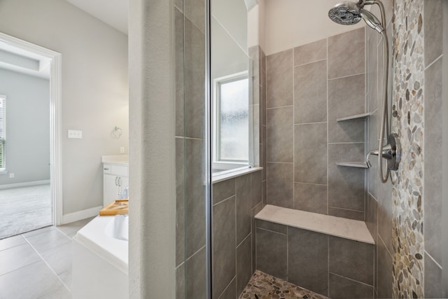 bathroom featuring tile patterned flooring and separate shower and tub