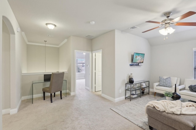 living room with ceiling fan, light colored carpet, and crown molding