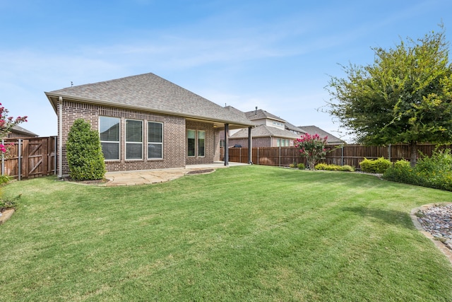 back of property with a patio area and a lawn