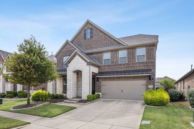 view of front of house featuring a garage and a front lawn