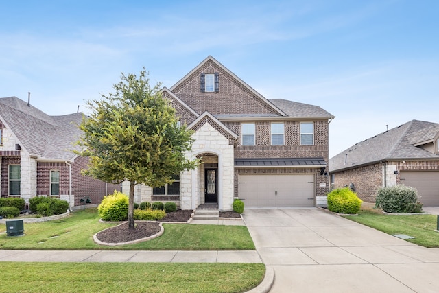 view of front of property featuring a garage and a front yard