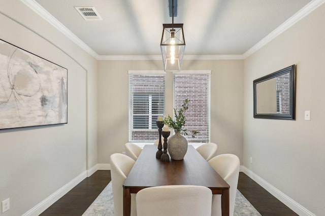 dining area featuring crown molding and dark hardwood / wood-style floors