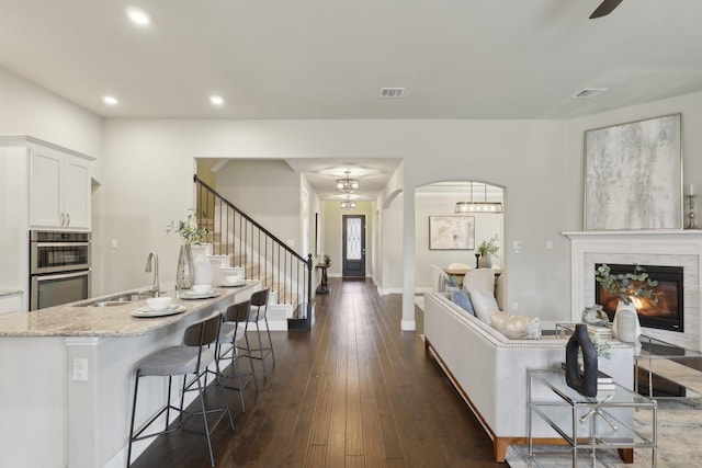 living room with dark hardwood / wood-style flooring and sink