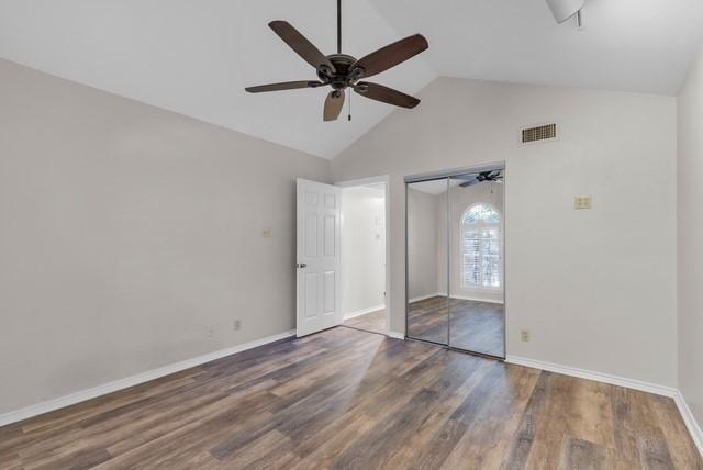 unfurnished bedroom featuring ceiling fan, high vaulted ceiling, and dark hardwood / wood-style floors