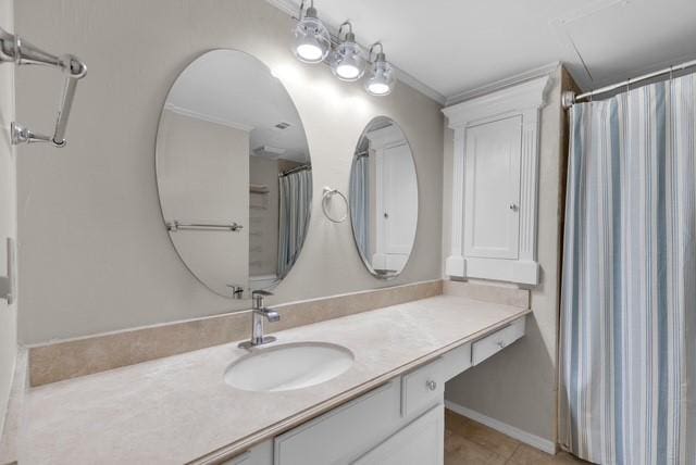 bathroom with tile patterned floors, vanity, and crown molding