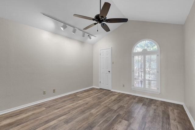 spare room featuring hardwood / wood-style flooring, ceiling fan, lofted ceiling, and rail lighting