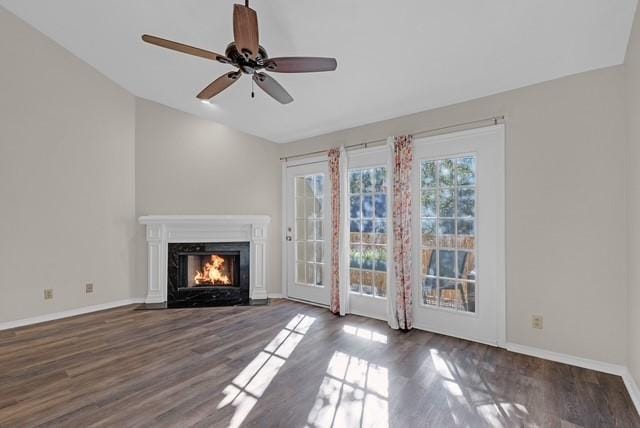 unfurnished living room with dark hardwood / wood-style floors and ceiling fan