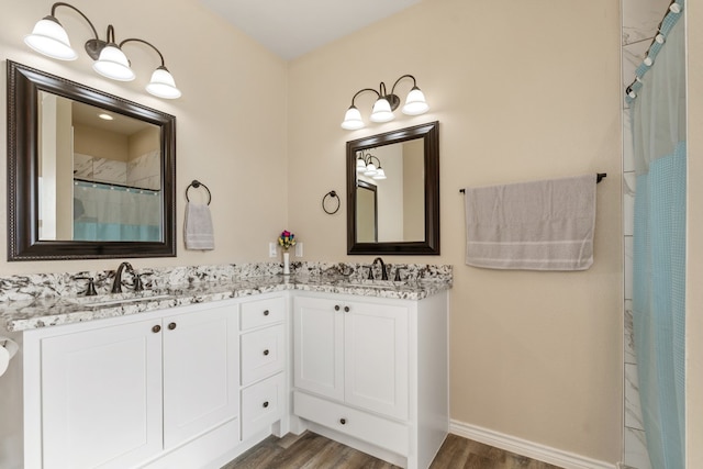 bathroom featuring wood-type flooring, vanity, and curtained shower