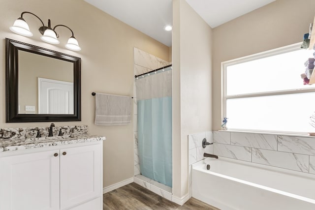 bathroom featuring hardwood / wood-style floors, vanity, and separate shower and tub