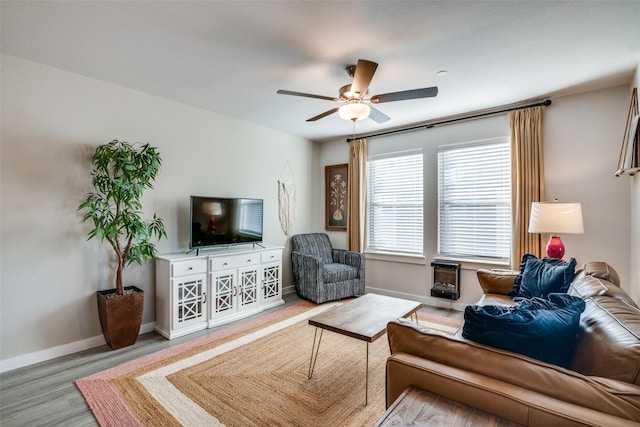 living room with light hardwood / wood-style floors and ceiling fan