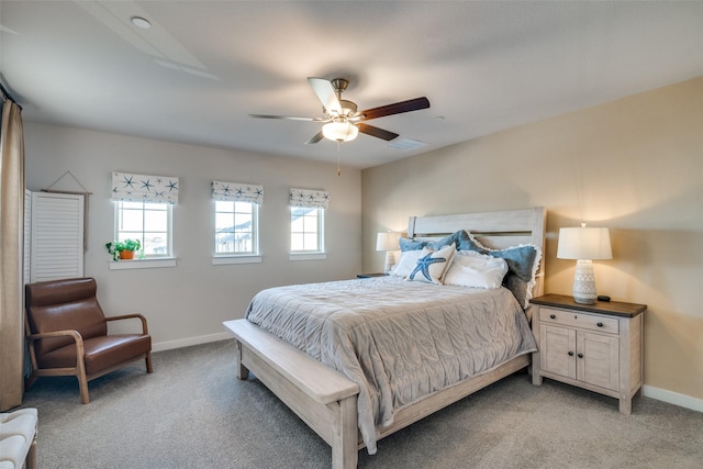 carpeted bedroom with multiple windows and ceiling fan