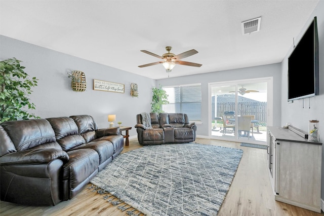 living room featuring ceiling fan and light wood-type flooring