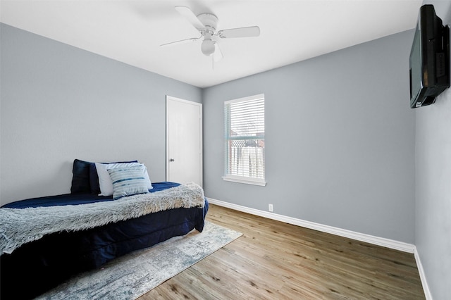 bedroom featuring hardwood / wood-style flooring and ceiling fan