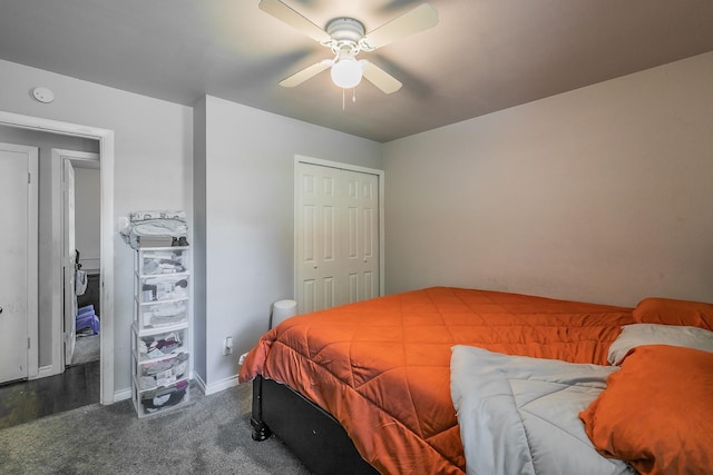 bedroom with dark colored carpet, ceiling fan, and a closet