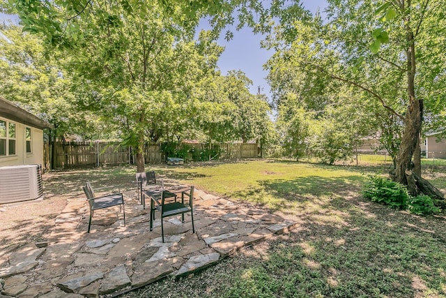 view of yard featuring central air condition unit and a patio area