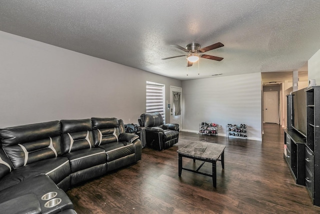 living room featuring dark hardwood / wood-style flooring, a textured ceiling, and ceiling fan