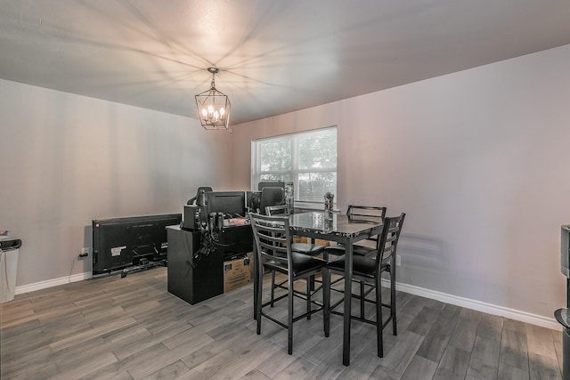 dining space with a chandelier and wood-type flooring