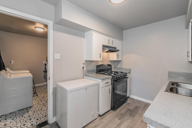 kitchen featuring white cabinetry, sink, light hardwood / wood-style flooring, black gas stove, and fridge