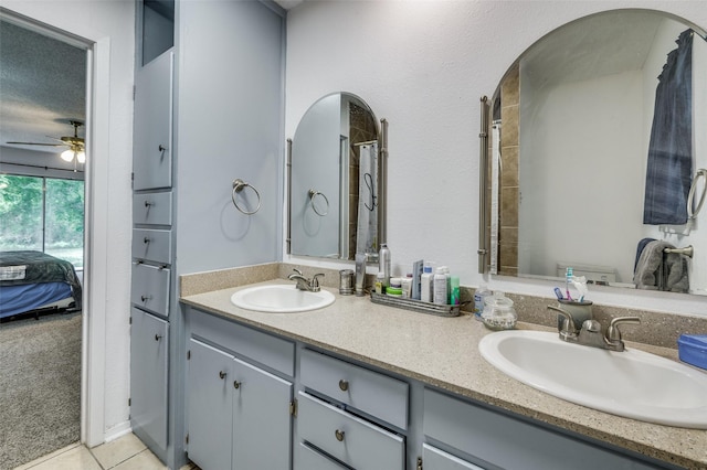 bathroom with ceiling fan, tile patterned flooring, and vanity