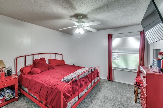 bedroom with ceiling fan, light colored carpet, and a textured ceiling