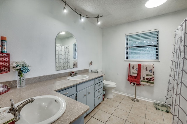 bathroom featuring walk in shower, tile patterned flooring, a textured ceiling, toilet, and vanity