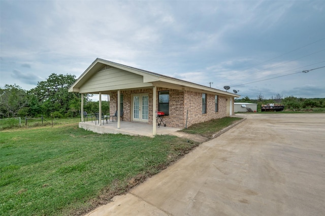 view of property exterior featuring a yard and a patio area