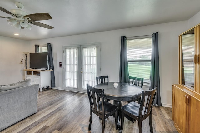 dining space featuring french doors, ceiling fan, and light wood-type flooring