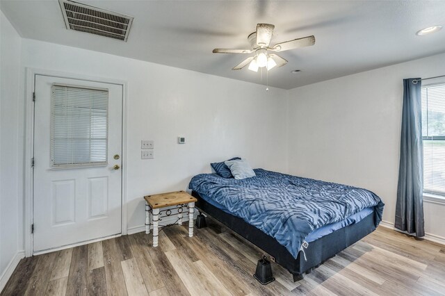 bedroom with hardwood / wood-style flooring and ceiling fan