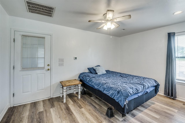 bedroom with hardwood / wood-style floors and ceiling fan