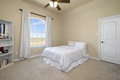 bedroom featuring ceiling fan and light carpet